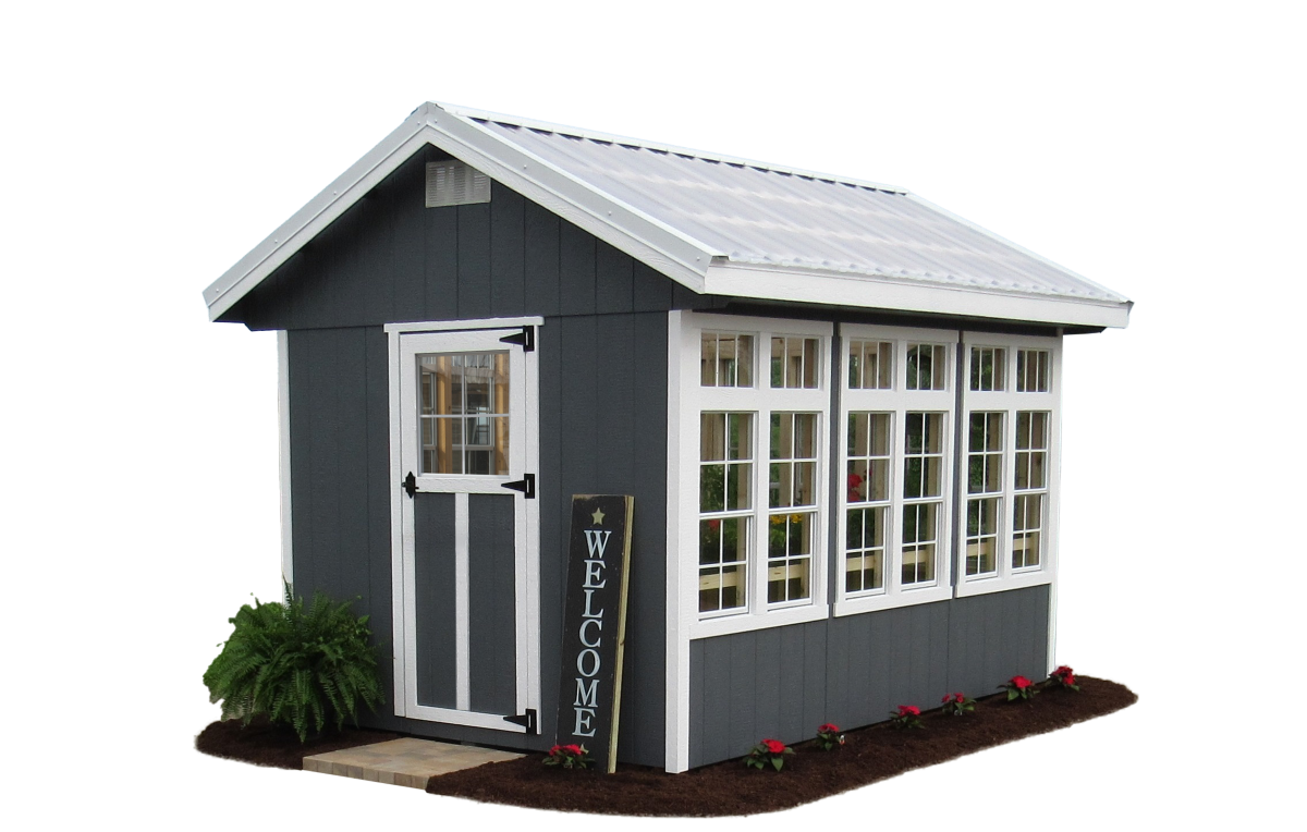 DIY garden shed kit with white-trim windows, metal roof, and a “Welcome” sign.